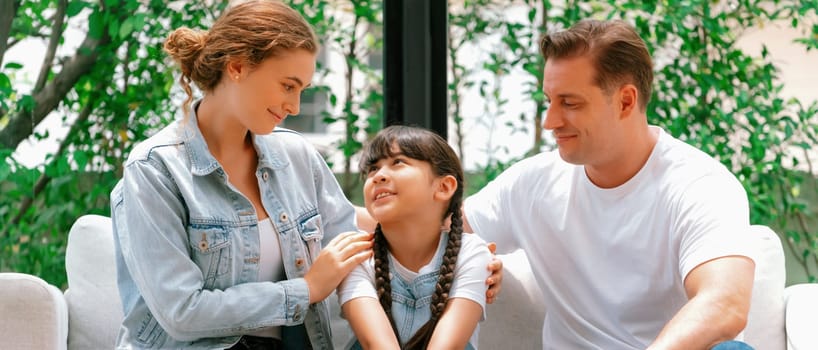 Parents comforting their daughter with loving hug, helping her feel secure and protected from fear, rest her head on shoulder. Happy family love and child care support concept. Panorama Synchronos