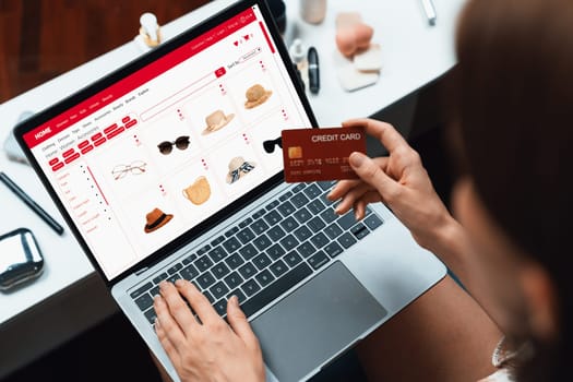 Woman shopping online on internet marketplace browsing for sale items for modern lifestyle and use credit card for online payment from wallet protected by utmost cyber security software