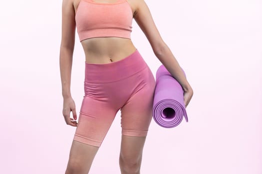 Young attractive asian woman portrait in sportswear with exercising mat. Healthy exercise and workout routine lifestyle concept. Studio shot isolated background. Vigorous