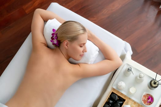 Panorama top view woman customer enjoying relaxing anti-stress spa massage and pampering with beauty skin recreation leisure in day light ambient salon spa at luxury resort or hotel. Quiescent