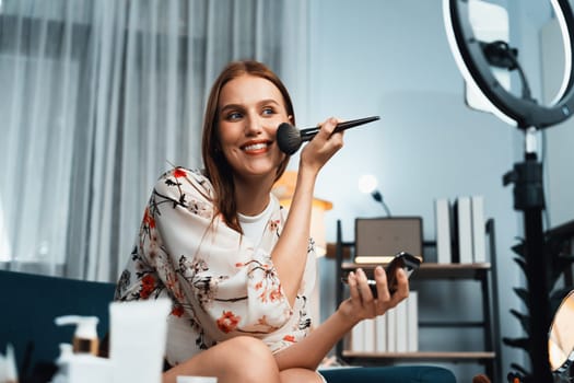 Woman influencer shoot live streaming vlog video review makeup utmost social media or blog. Happy young girl with cosmetics studio lighting for marketing recording session broadcasting online.