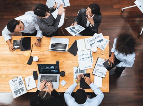 Top view multiracial analyst team use BI dashboard display on laptop screen, analyzing financial data for strategic decision. Fintech analyzes marketing indicators. Concord