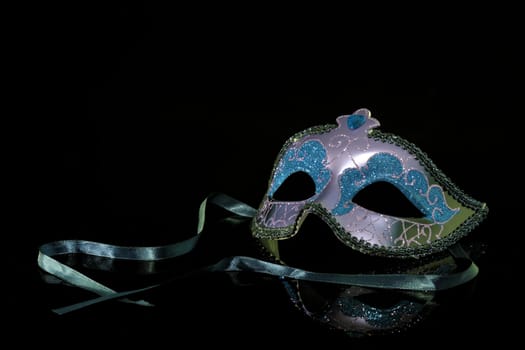 A Carnival Mask on black with reflection