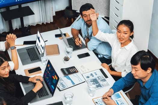 Office worker raise hand up asking for question during business meeting on data analysis using BI or business intelligence software for marketing and strategic planning. Prudent