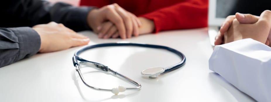 Couple attend fertility or medical consultation with gynecologist at hospital as family planning care for pregnancy. Husband and wife consoling each other through doctor appointment. Panorama Rigid