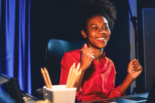 Working African woman with happy glowing, smiling face, getting new job project with good deal or marketing course scholarship information on laptop screen. Concept of cheerful expression. Tastemaker.