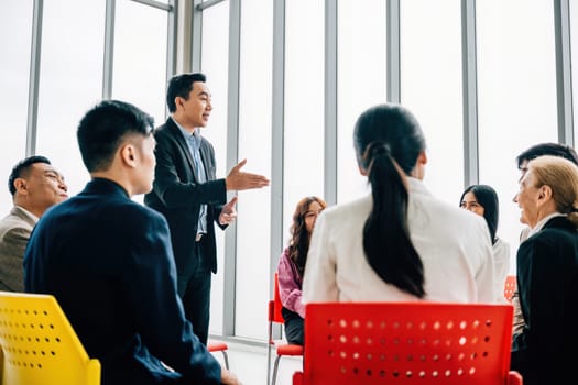 In a modern office, multiethnic businesspeople work and discuss together. They present, brainstorm, and plan, highlighting teamwork, diversity, and confidence in their meeting.
