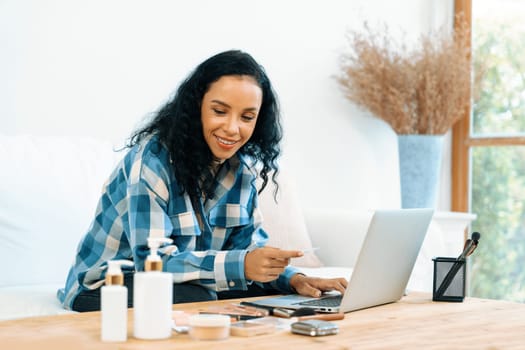 Young happy woman buy product by online shopping at home while ordering items from the internet with credit card online payment system protected by crucial cyber security from online store platform