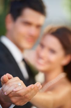 Hands, ring and a couple on their wedding day for love, romance or celebration at a marriage ceremony. Trust, commitment or promise with a bride and groom together at an event to get married closeup.