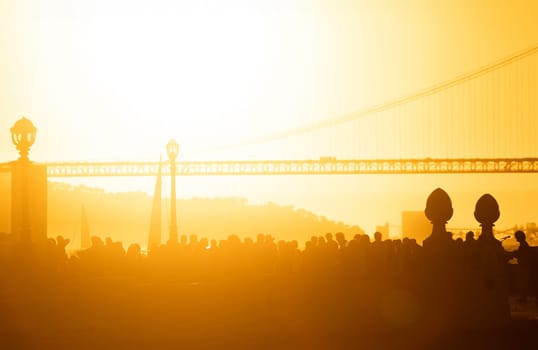 A group of people standing in front of a bridge