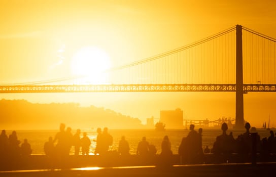 A group of people standing in front of a bridge