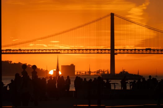 A group of people standing in front of a bridge