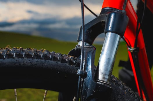 high-speed bicycle disc brake system, perforated disc and caliper, mtb, close-up, mountain bike brake efficiency.