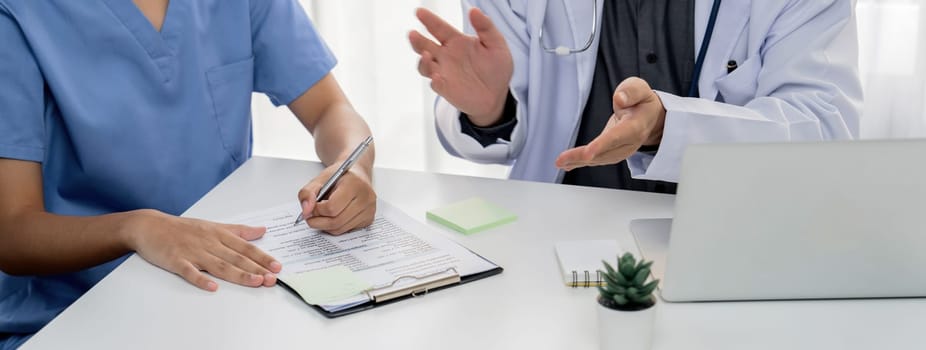 Professional various team of medical working and planning medical treatment at hospital table together. Teamwork lead to successful illness and sickness treatment. Panorama Rigid