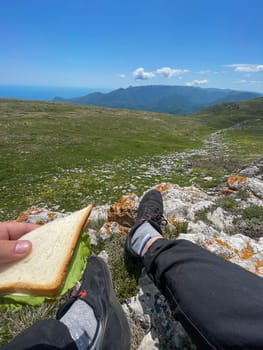 food on a hike man with bread sitting on a mountain journey
