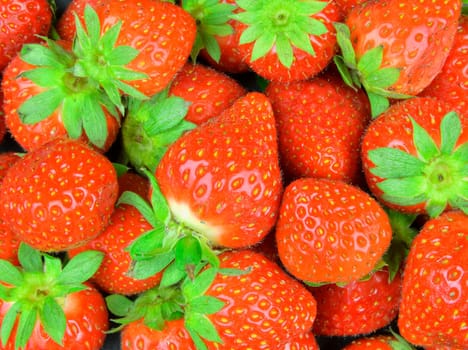 Color macro shot of strawberries. Strawberry image suitable as background for supermarkets, vegetable shops, garden market. Concept for restaurants, ice cream shops and fruit bars.