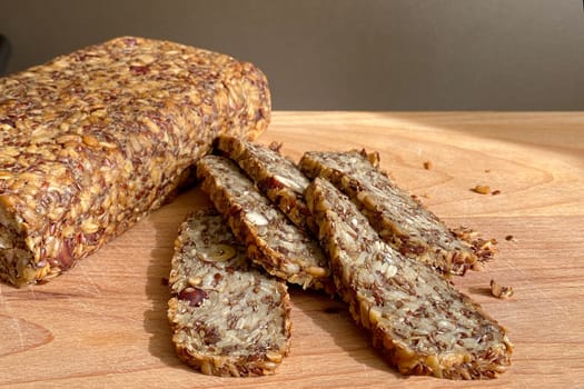 Homemade glutenfree bread with hazelnut and flax seeds on a wooden Board background close-up. Food for diet and health. Healthy almond bread, Keto, ketogenic diet, paleo, low carb fat.