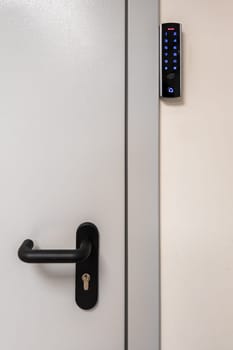 gray metal door with black handle and digital touch sensor RFID lock.