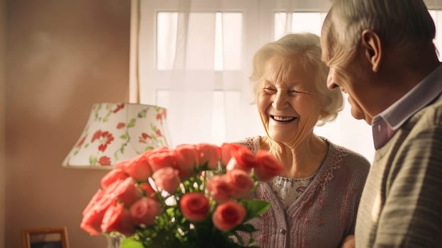 Gorgeous, happy, smiling, handsome, sweet, elderly couple. A gray-haired husband gives a large bouquet of red roses to his happy, laughing wife. Valentine's day, newlyweds, engagement, holiday, birthday, wedding, anniversary, surprise date