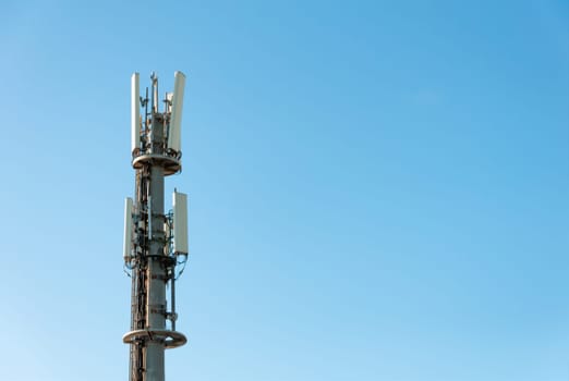 communication tower close-up over the blue sky on the right there is a place for an inscription, a shot from the height of the tower close-up. High quality photo