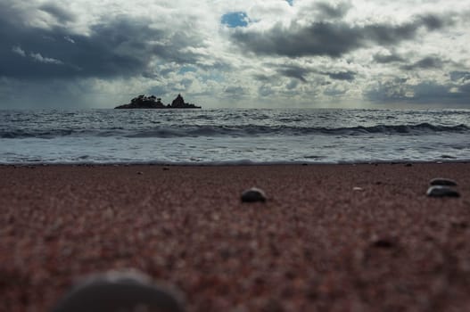 landscape photo of an evening beach overlooking the sea, an island can be seen in the distance, a photo of a sunset on the sea. High quality photo