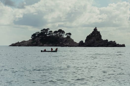 landscape photography of the sea, a beautiful landscape, there is a place for an inscription. In the sea, an island in the distance and a boat on the water nearby. High quality photo