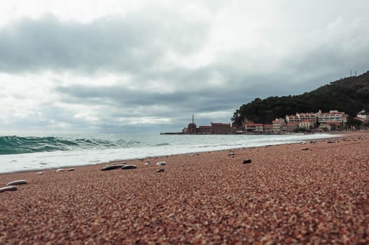 a beautiful old town on the seashore, in the background a mountain with trees, a beautiful seascape. High quality photo