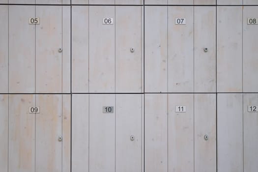 brown wooden lockers for storing things in the store. Lockers with numbers and a lock close-up. High quality photo