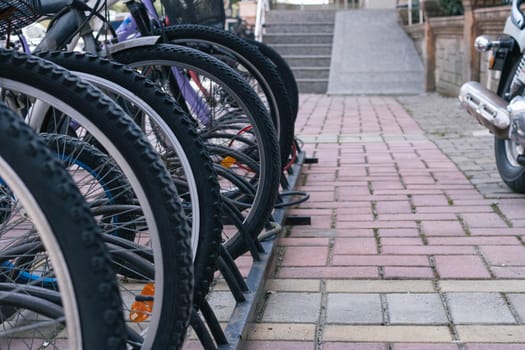 parking with bicycles on the street, at the entrance to the store. Close-up of the wheel . High quality photo