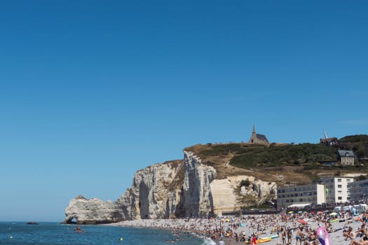 beach with people in France in the city of Etretat Normandy, a beautiful background of sea nature. 31 June 2022 High quality photo