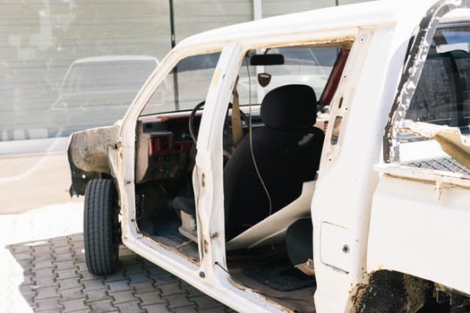 a broken car stands for repairs without doors and hood.Car repair concept. High quality photo