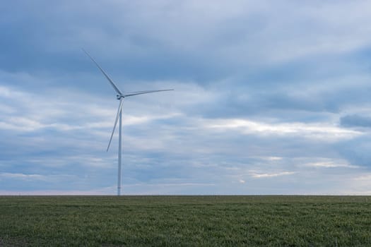 a meadow with wind turbines that generate electricity on the right there is a place for inscriptions. High quality photo