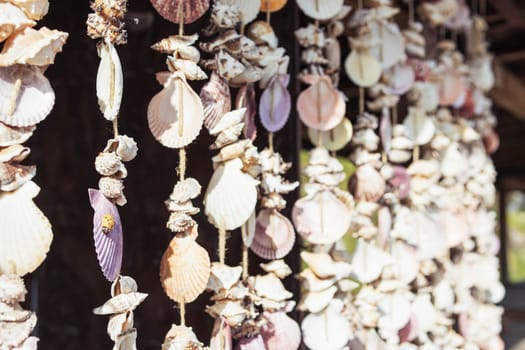 pendants with multi-colored shells are made by hand, they hang in the store for sale. High quality photo