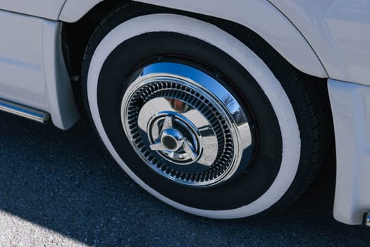 close-up of a wheel from a new white car parked in a parking lot. High quality photo