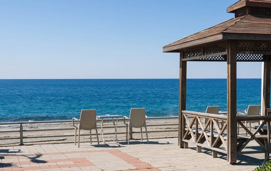 Beautiful view of the seashore, beach, sea, view from the cafe on the seashore. The background is beautiful, a place for an inscription. High quality photo