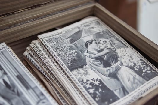 antique magazines are sold at the fair. there is a place for an inscription on the side, a close-up picture. A fair in a French city, the magazines are in a box. High quality photo