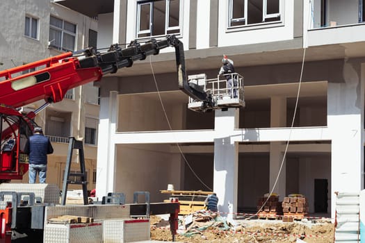 home repair, workers make the facade of the house on the tower, restoration of the building. High quality photo