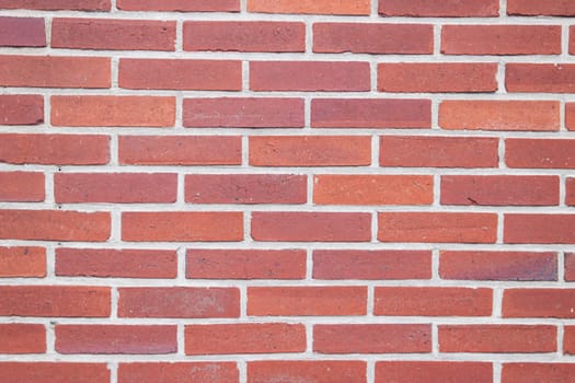 wall with red small bricks, background for a screensaver with a place for an inscription. High quality photo