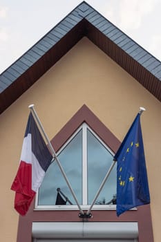 The flag of the European Union and the flag of France flutters in the wind close-up. High quality photo