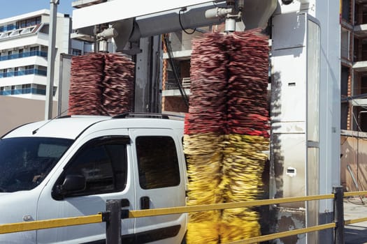 A car goes through an automatic car wash.White car during a car wash. High quality photo