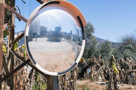 Signs in the form of round convex glass placed on the road, which is dramatically bent so that people can see drivers from the opposite direction. High quality photo