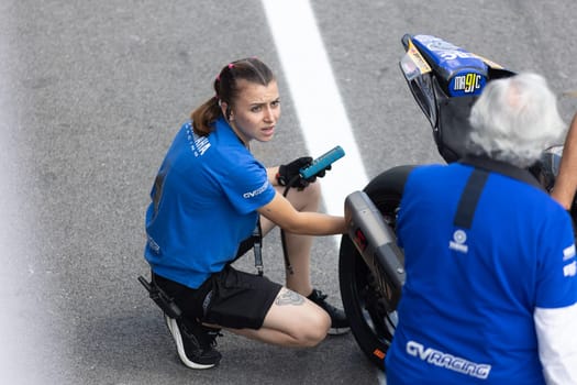 6 may 2023, Estoril, Portugal - MotoGP racing - woman repaer helps with Motorcycle - telephoto