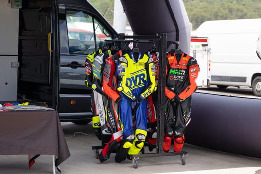 6 may 2023, Estoril, Portugal - MotoGP racing - A rack of motorbike gear in front of a van