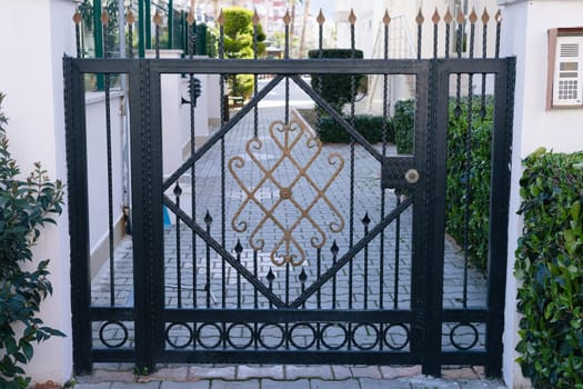 Metal wrought gates in a multi-storey complex.Worn iron. Metal fence High quality photo