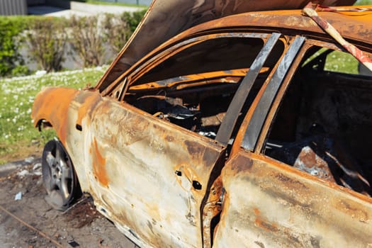 Burnt car with burnt condition in isolation on the side of the road in the wild. High quality photo