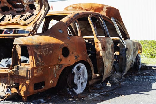 a burned-out car in the parking lot near the visa shop at the back of one half, there is a place for an inscription. Car insurance against fire. High quality photo