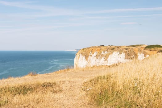 view from the mountain to the ocean, around dry grass all around on the mountain. Beautiful landscape near the sea. High quality photo