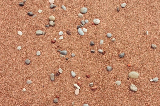 background beach with sand with pebbles with a place for an inscription, close-up. High quality photo