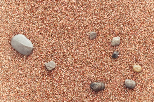 beach with yellow sand close-up, beautiful stones in the frame, background with a place for an inscription. High quality photo