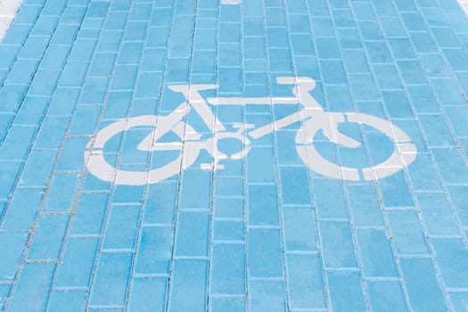 Bicycle path in blue close-up.Bicycle painted with white paint on the road. High quality photo